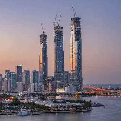 Miami's skyline features numerous modern supertall skyscrapers under a clear sky.